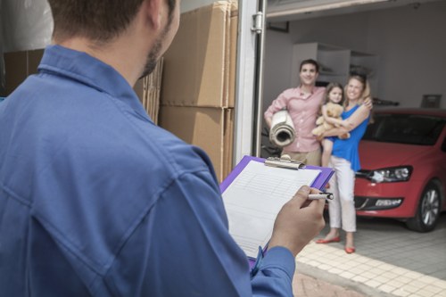 Professional movers carrying furniture from a South Woodford property