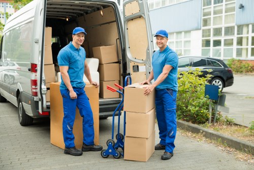 Mover wearing PPE while loading items into a van