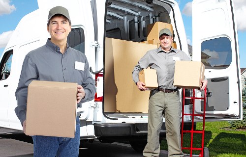 Furniture and boxes being packed into a removal van